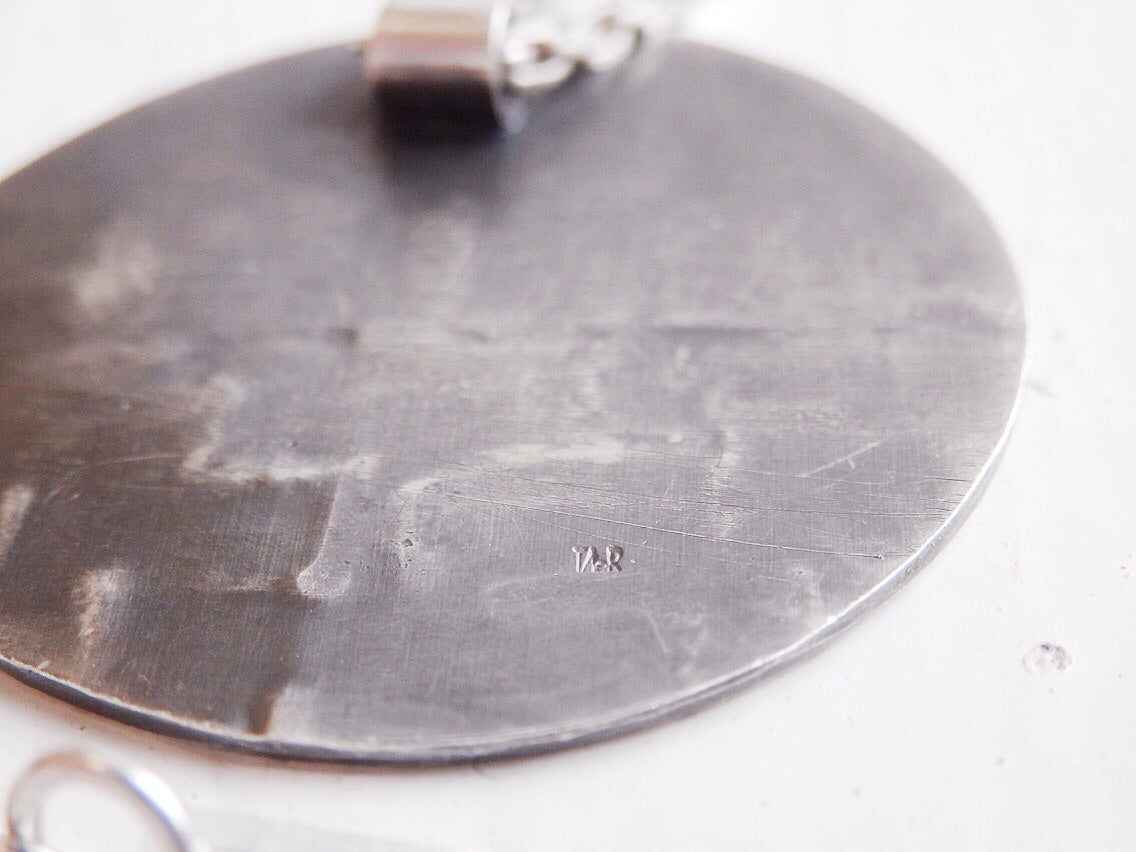 tiny stamp logo on silver disc